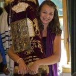 bat mitzvah carrying the Torah